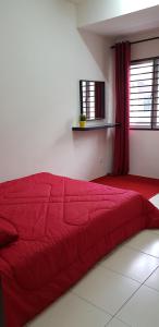 a red bed in a white room with a window at MY Homestay KLIA in Sepang