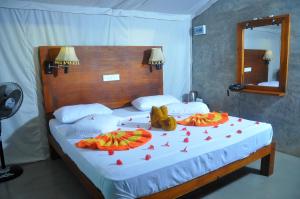 a bedroom with a large bed with hearts on it at Kottawatta Village in Udawalawe