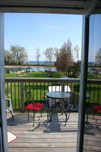 a patio with a table and chairs and a view of a lake at Hadovka Lakeside Inn in Wellington