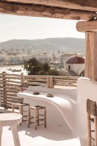 
a white toilet sitting on top of a wooden table at MyCocoon Hostel in Mikonos
