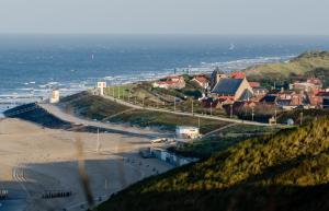 a view of a beach with houses and the ocean at TINY HOUSE MIMI Bed by the Sea - Adults only in Zoutelande