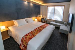 a hotel room with a large bed and a chair at Miru Kyoto Nishiki in Kyoto +22 photos