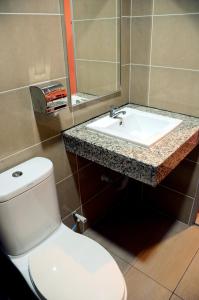 Łazienka z białą toaletą i umywalką w obiekcie Hotel Sri Rembia w Malakce