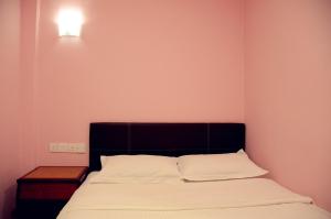 Postel nebo postele na pokoji v ubytování Hotel Sri Rembia