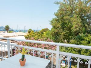 a white balcony with a table and a plant at Alkyon Hotel in Limenas