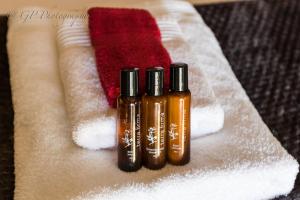 three bottles of essential oils sitting on a towel at Laguna Lodge in Graskop
