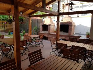 a patio with tables and chairs and a fireplace at Mar-Mari's in Eforie Nord