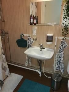 a bathroom with a white sink and a mirror at RBA RentHouse Apartment 1 in Nedervetil