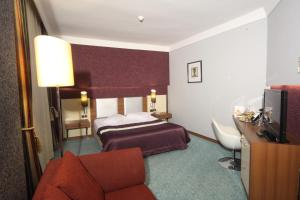 A bed or beds in a room at Suhan Cappadocia Hotel & Spa