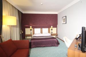 A bed or beds in a room at Suhan Cappadocia Hotel & Spa