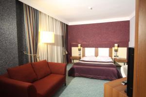 A bed or beds in a room at Suhan Cappadocia Hotel & Spa