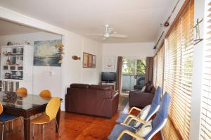 a living room with a couch and a table and chairs at 45 HALFORD - PET FRIENDLY in Inverloch