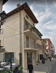 a man walking down a street in front of a building at Casa Pastoricchio in Grado