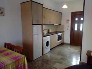 a kitchen with a refrigerator and a washer and dryer at Molivos View Studios in Mithymna