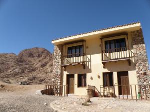 a building in the desert with mountains in the background at Daniela Village St.Katherine in Saint Catherine