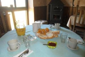 a table with a plate of bread and a drink at La Posada del Arba in El Frago