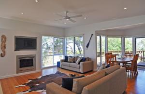 a living room with a couch and a fireplace at SCARBOROUGH Serenity in Inverloch