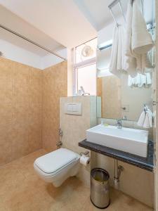 ein Bad mit einem WC und einem Waschbecken in der Unterkunft Cosmo Annora in Bangalore