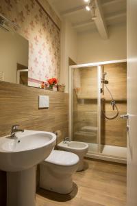 a bathroom with a sink and a toilet and a shower at Apartments Florence - Fiesolana Balcony in Florence