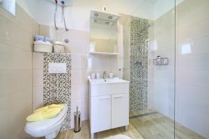 a bathroom with a toilet and a sink and a shower at Apartment Nena in Krk +25 photos