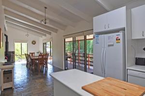 a kitchen with a refrigerator and a dining room at WAVELENGTH - WIFI & PET FRIENDLY (OUTSIDE ONLY) in Inverloch