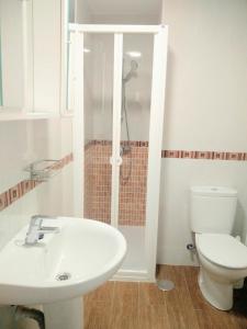 a bathroom with a sink and a toilet and a shower at San Lorenzo House in Gijón