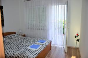 Postel nebo postele na pokoji v ubytování Apartmani Novosel