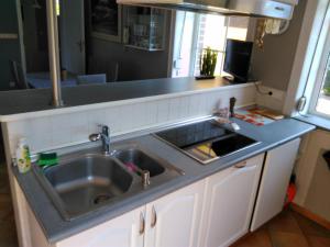 a kitchen with a sink and a counter top at Willa u Andrzeja in Gołdap