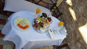 a white table with plates of food on it at Petrino in Rhodes Town