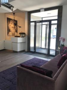 a living room with a couch and a large window at Trip Inn PostApart Aschaffenburg in Aschaffenburg