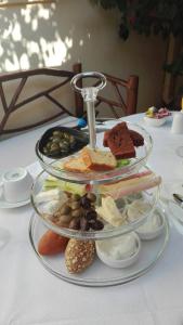 a three tiered plate of food on a table at Petrino in Rhodes Town