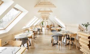 a restaurant with tables and chairs and skylights at Villa Nova in Zakopane
