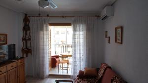 a living room with a couch and a sliding glass door at Studio w La Mata in La Mata