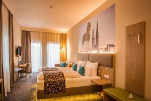Postel nebo postele na pokoji v ubytování AKZENT Hotel Villa Saxer