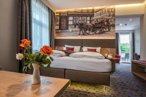 Postel nebo postele na pokoji v ubytování AKZENT Hotel Villa Saxer