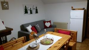 a living room with a table and a couch at il bosco in casa in Telve