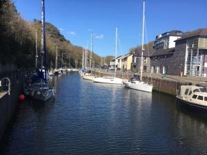 a group of boats are docked in a canal at Stunning House in Felinheli Marina in Y Felinheli