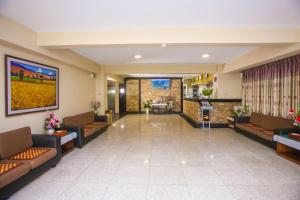 a lobby of a hospital with couches and chairs at Grace Treasure Hotel in Yangon