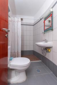 a bathroom with a toilet and a sink at Ta Spitakia Tsarbopoulos in Kyparissia