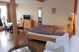 a bedroom with a bed and a living room at Ferienwohnung Tilli in Zell an der Mosel