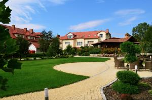 a house with a green lawn and a walkway at Hotel Panorama in Ostrowiec Świętokrzyski