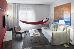 a living room with a couch and a hammock in it at Casa Camper Barcelona in Barcelona