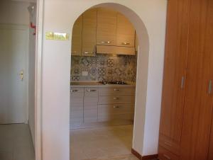 a kitchen with an archway leading into a room at Villa Maria Carla in Capoliveri +32 photos
