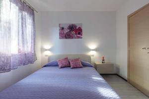 Ein Bett oder Betten in einem Zimmer der Unterkunft Apartments Villa Tre Marie
