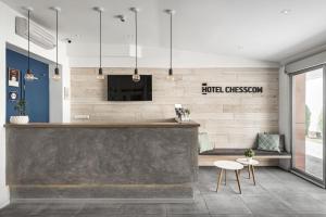 a lobby of a hotel reception with a large concrete counter at Hotel Chesscom in Budapest
