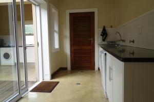 una cocina con una puerta que da a una lavandería en Twin Rivers Villa, en Plettenberg Bay 57 fotos más