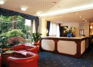 un hall avec des fauteuils en cuir rouge et un bar dans l'établissement Hotel Il Burchiello, à Mira