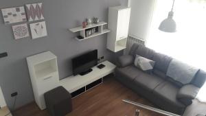 a living room with a couch and a flat screen tv at App. Adriatic Aurora in Umag