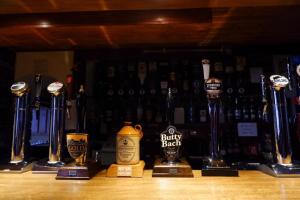 a row of trophies on a bar with bottles of wine at Castle Inn in Knighton