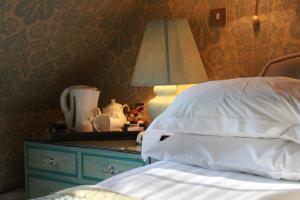 A bed or beds in a room at Roman Camp Country House Hotel 